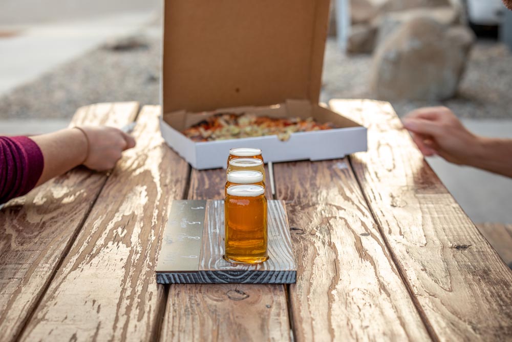 Detailed shot of guest enjoying pizza and beer at the Historic Hayden Granary.
