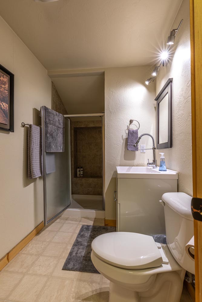 Full bathroom with shower inside the Brewery Abode air B&B.