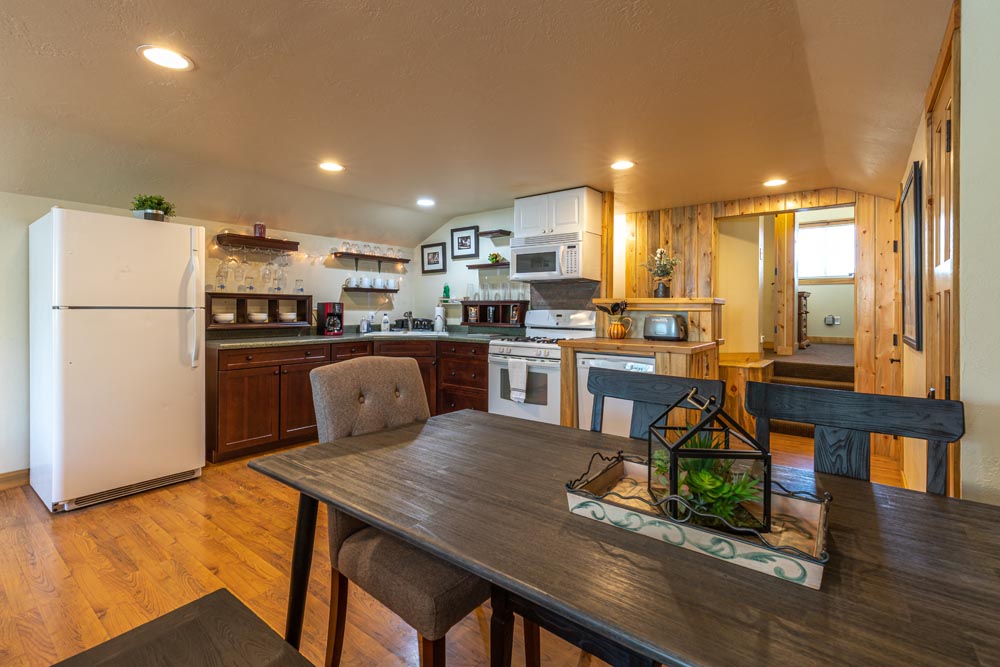 Dining table inside a full kitchen at the Brewery Abode air B&B.