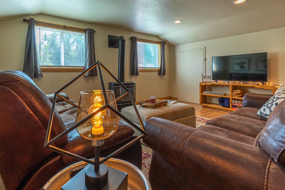 Living room with fireplace and flat screen TV in the Brewery Abode air b&b.