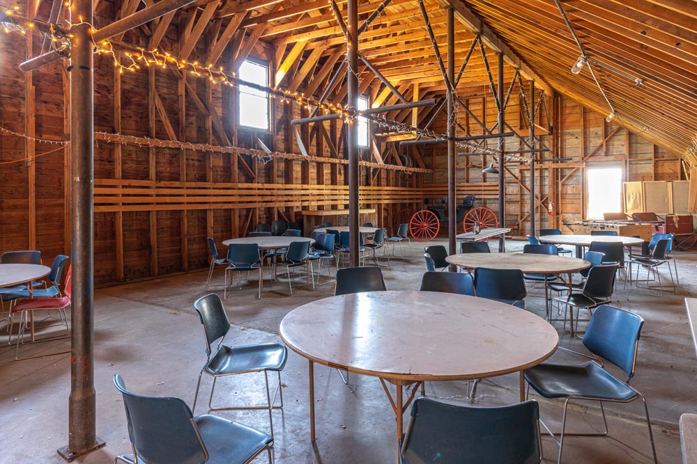 Tables and chairs set up inside the indoor dance hall at the historic Hayden Granary.