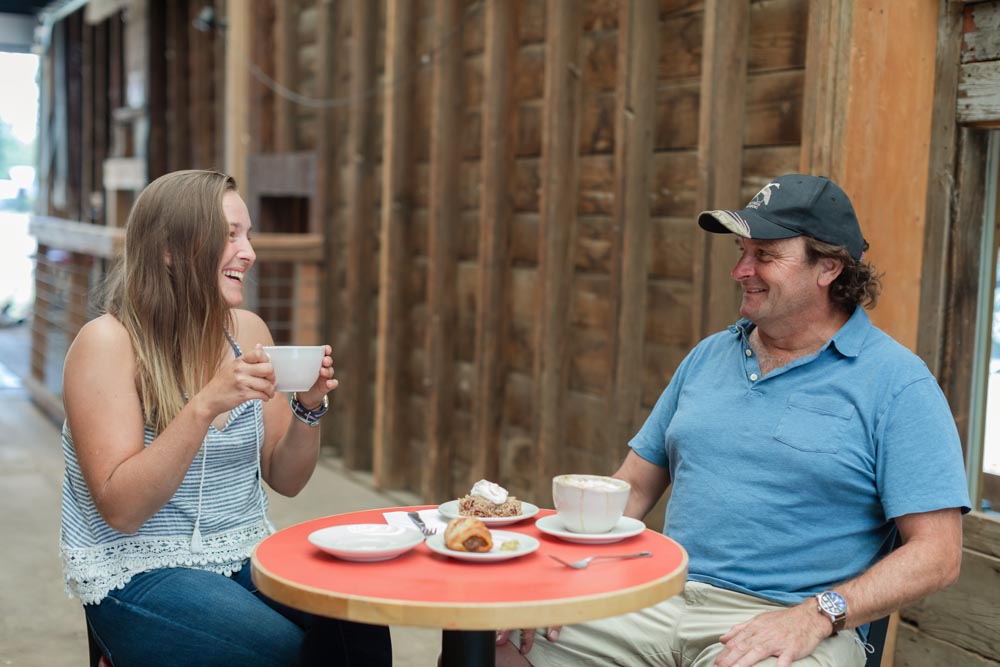 Patrons laughing together as they enjoy coffee and food from Wild Goose Granary inside the Historic Hayden Granary.