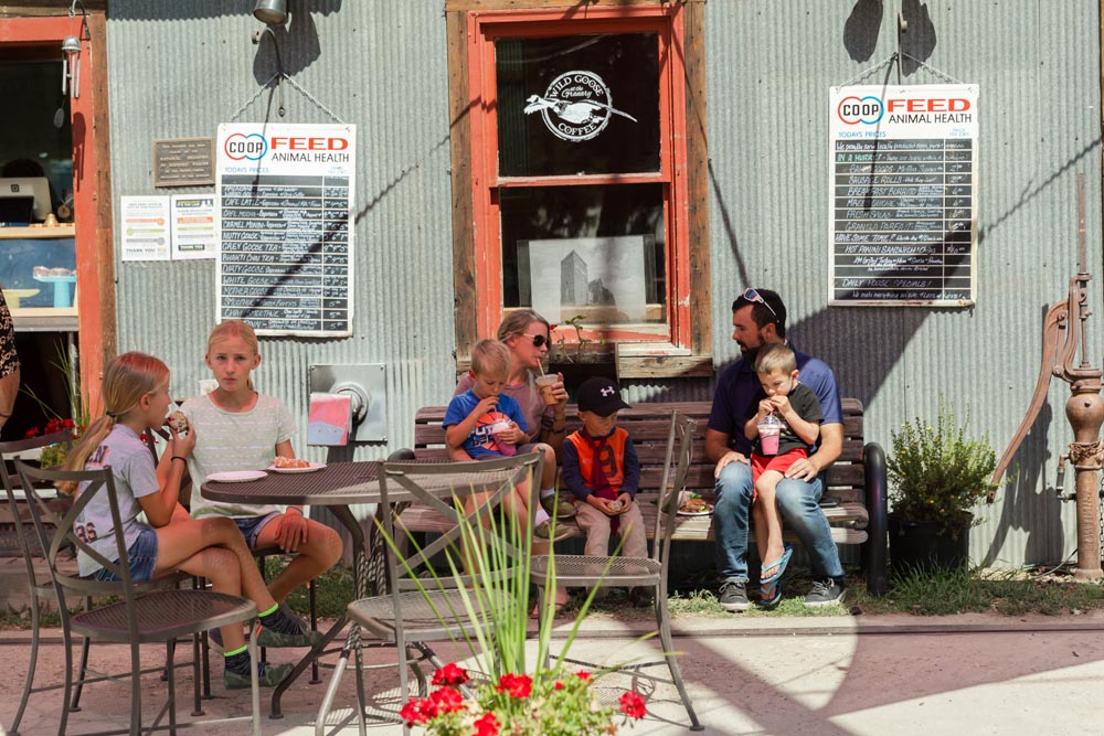 Family with kids enjoying food on a nice day at Wild Goose Coffee at the Historic Hayden Granary