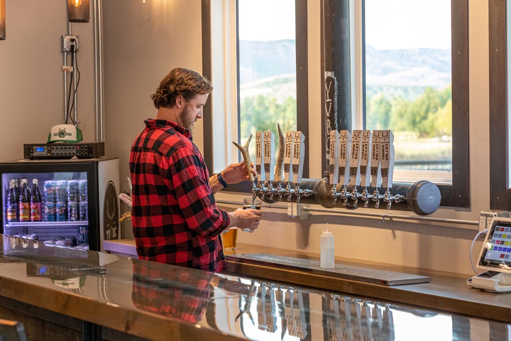 Yampa Valley Brewing Brew master pouring a beer on tap.