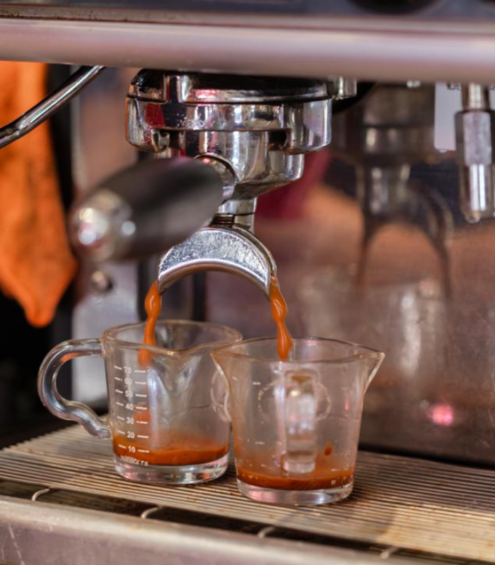 Detailed shot of expresso machine brewing expresso at the Wild Good Coffee shop.