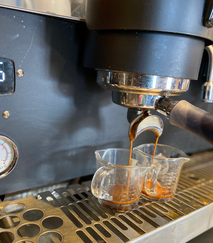 Detailed shot of expresso machine brewing expresso at the Wild Good Coffee shop.
